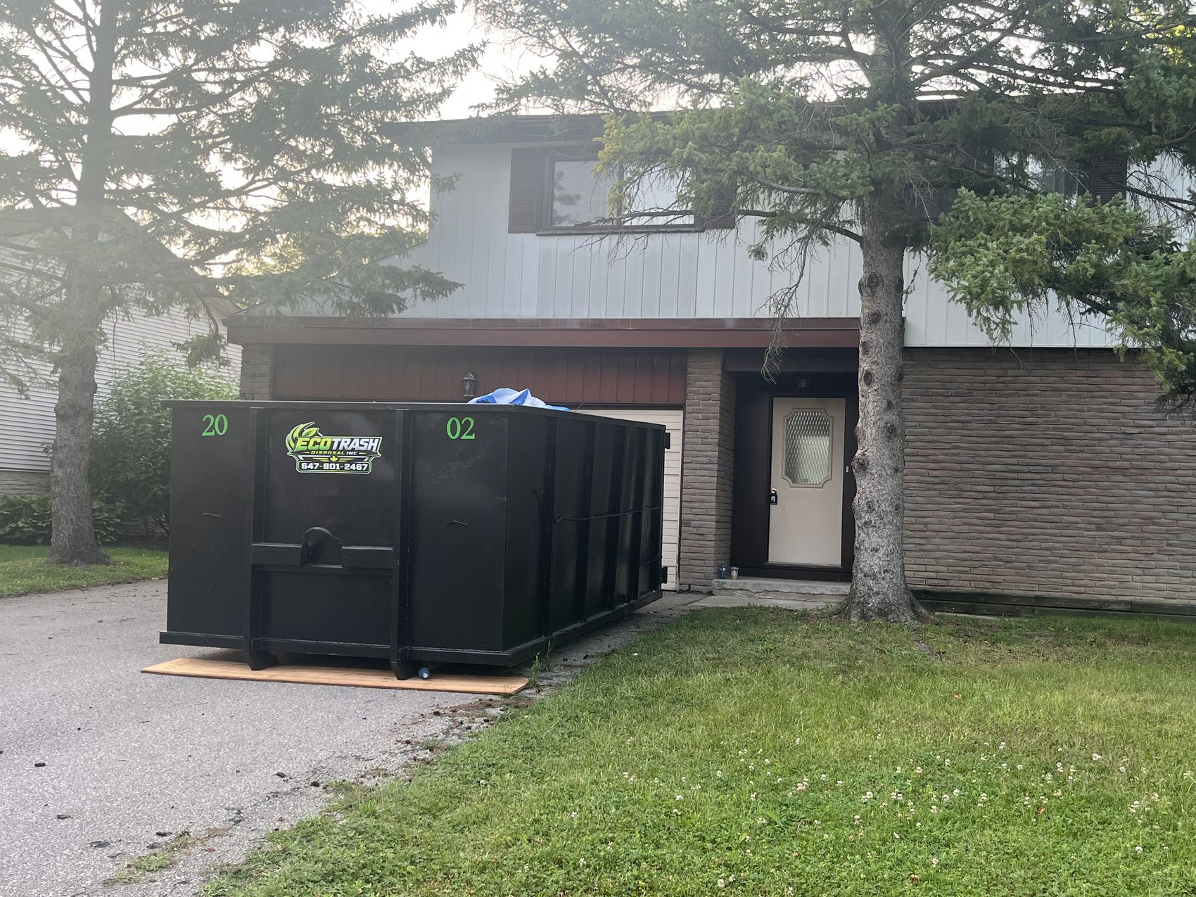 A 20 yard Eco Trash bin on a residential driveway