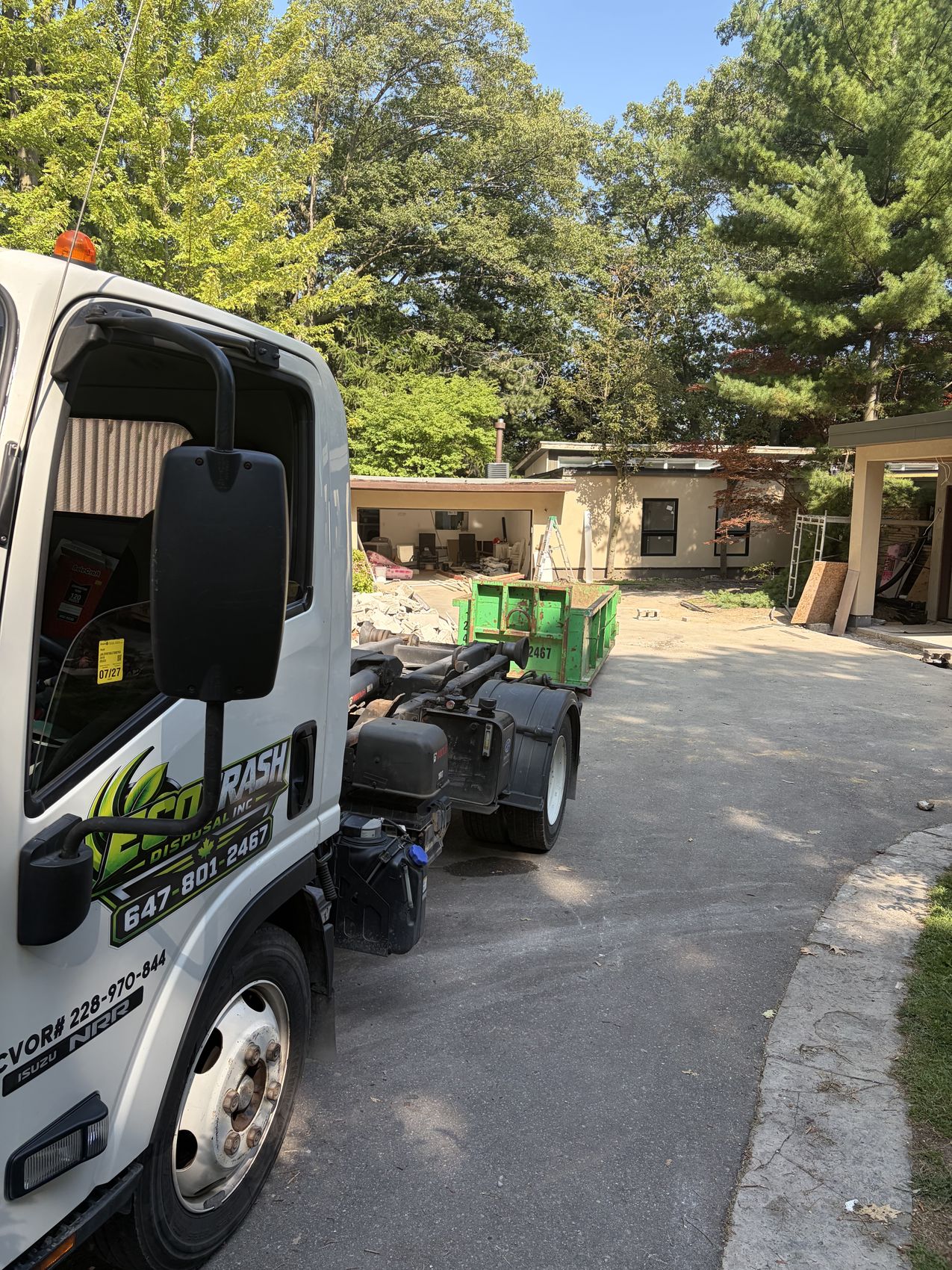 Eco Trash truck and green bin at a mid-century home renovation